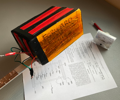 Finished fan-built T-Blade thruster beside the patent drawing
